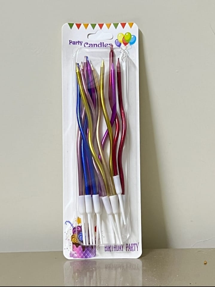 Packaged colorful birthday candles on a white background