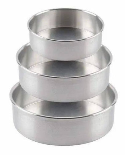 Set of three metallic measuring cups on a black background