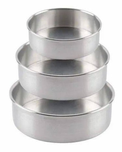 Set of three metallic measuring cups on a black background